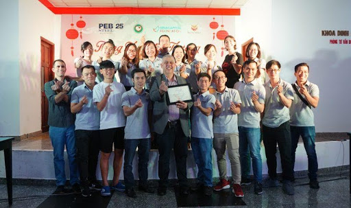 Leaders and staff of PEB Steel Buildings take a photo together.